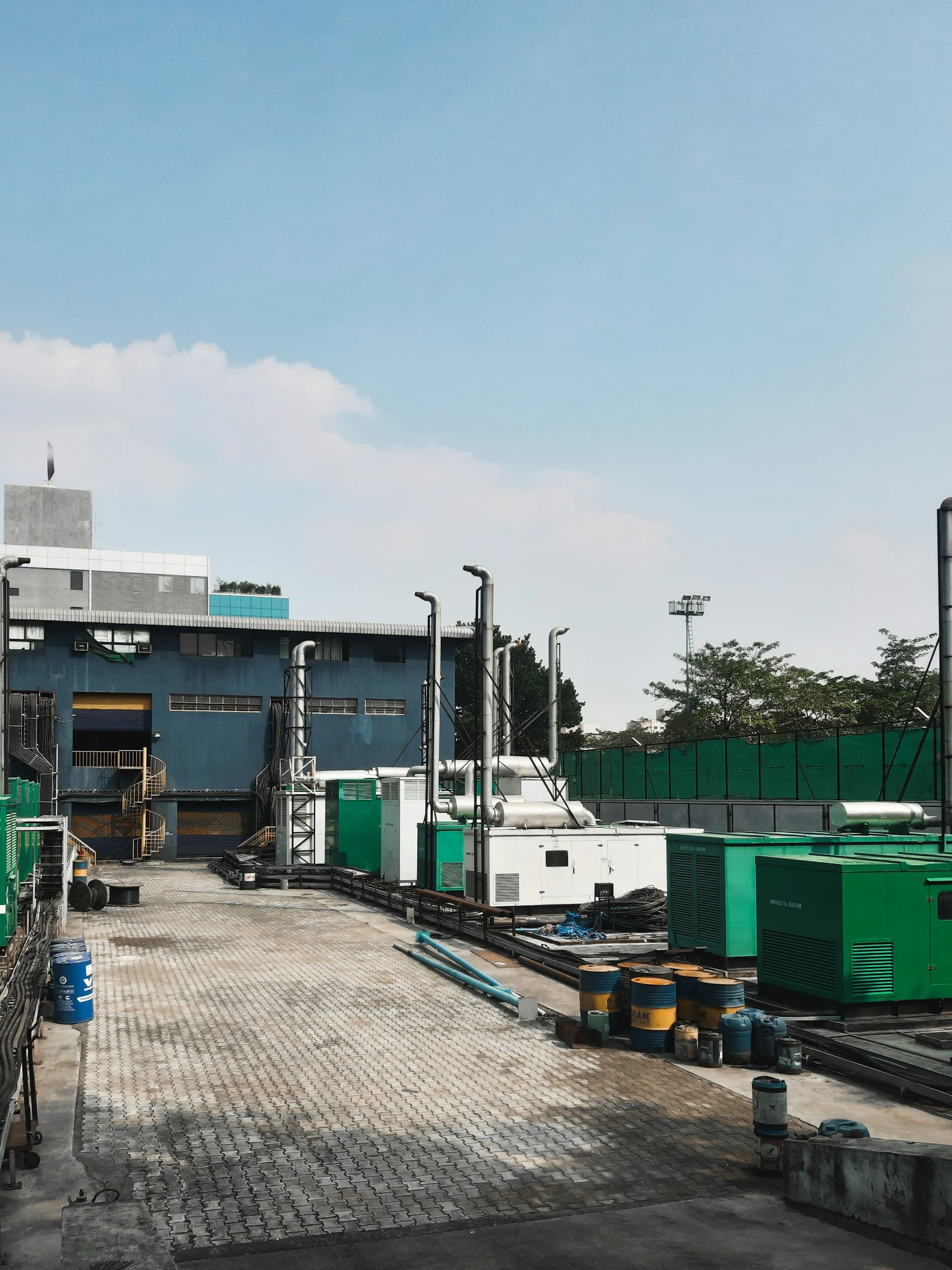Generator sets and exhaust stacks installed in a row at an industrial power facility